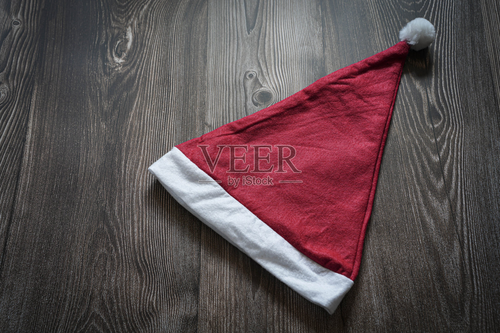 孤立的圣诞帽放在木质背景上,留有文字空间照片摄影图片