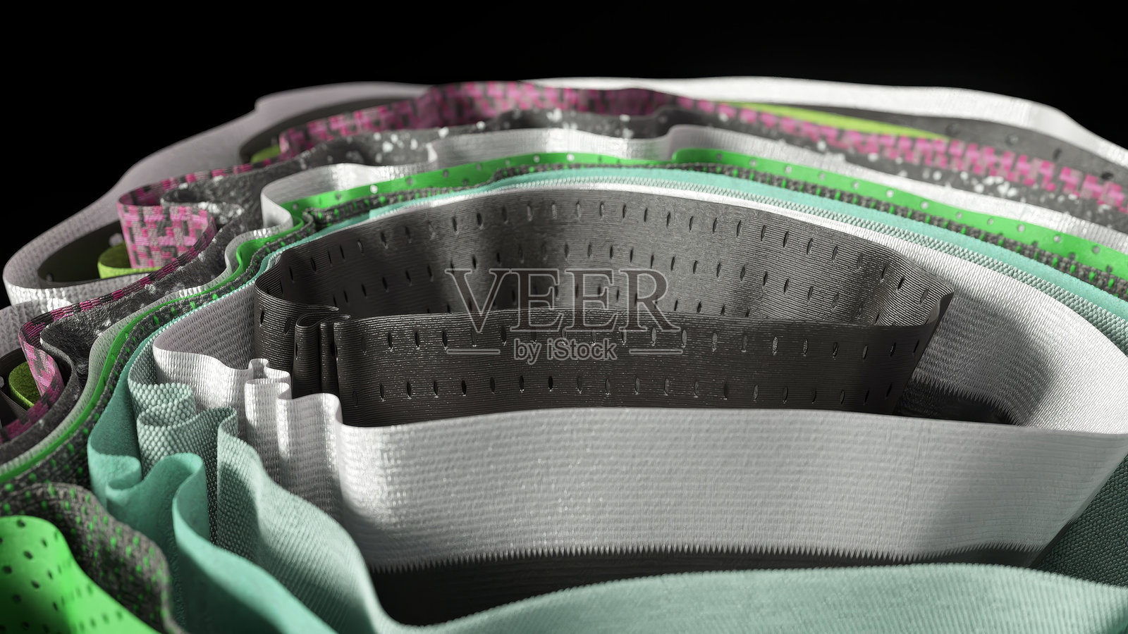 透气的彩色打孔面料层形成波浪形图案,突显现代纺织技术在运动服装和鞋类应用中对通风和灵活性的需求照片摄影图片