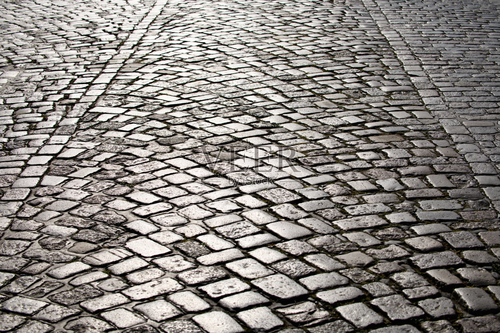鹅卵石铺成的背景。鹅卵石道路的纹理背景。用于背景的鹅卵石铺路。鹅卵石道路背景。照片摄影图片