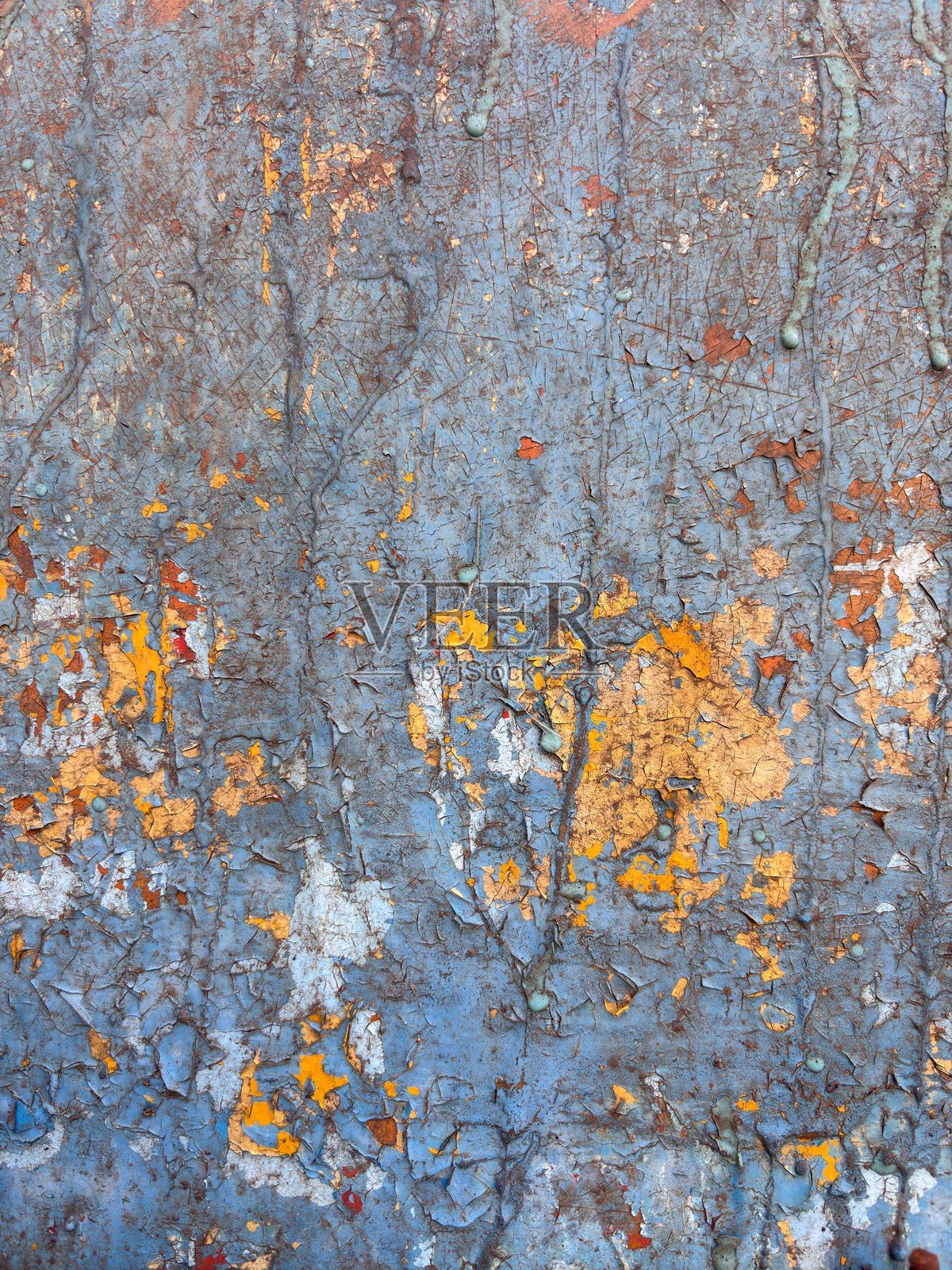 一面有蓝色和黄色油漆飞溅的墙壁照片摄影图片