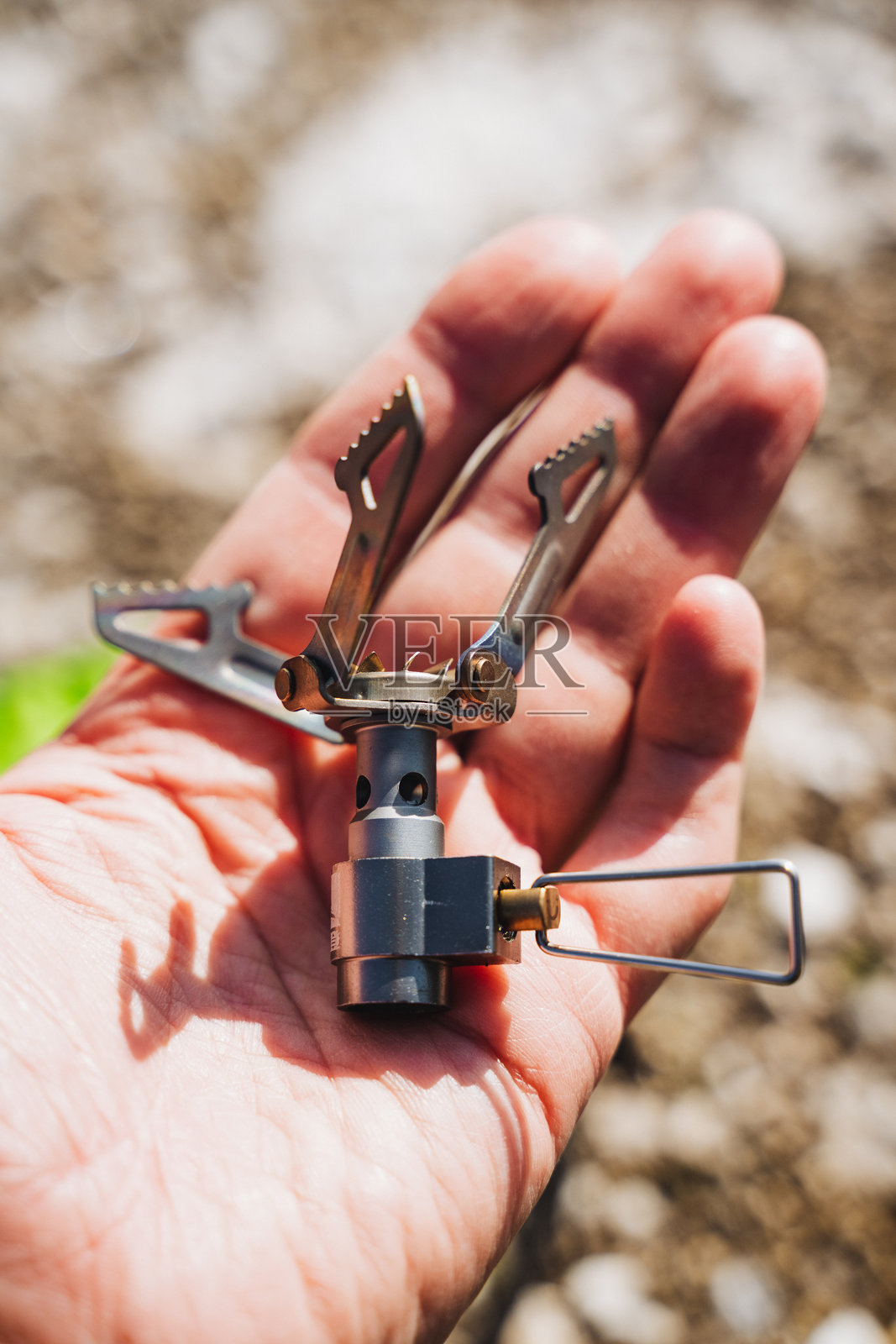 一个人小心翼翼地将一个便携式炉子牢牢握在手中照片摄影图片