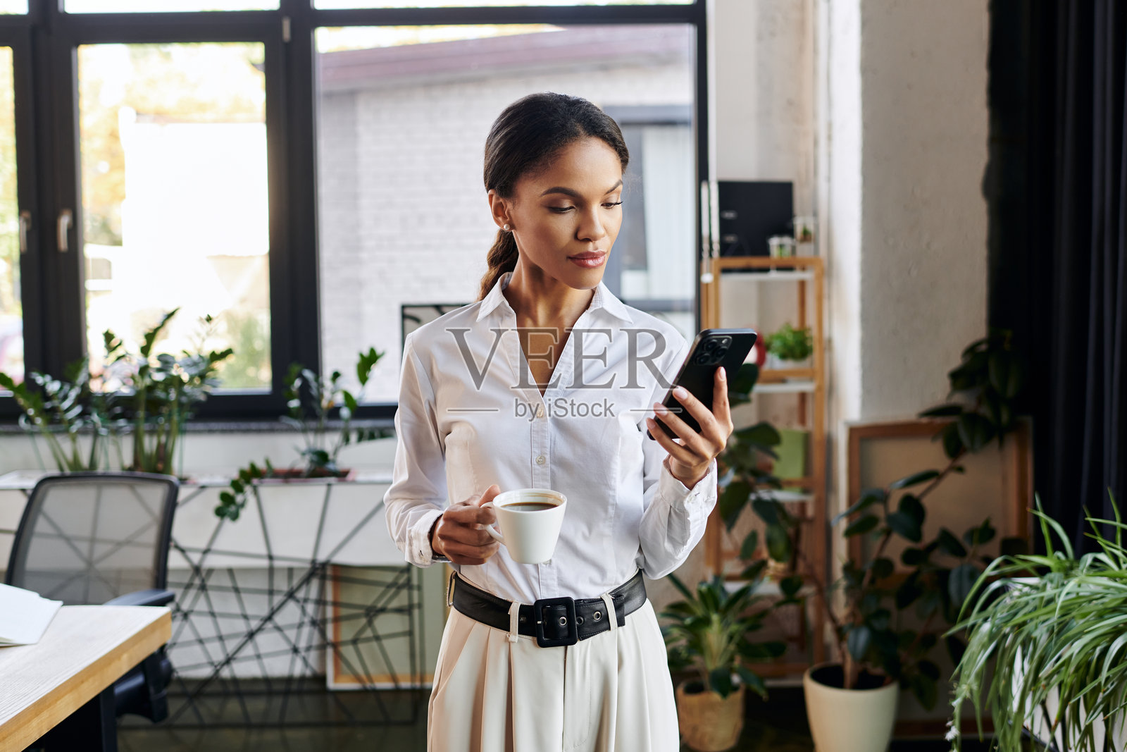 年轻的非裔美国女商人在现代办公室专注于工作照片摄影图片