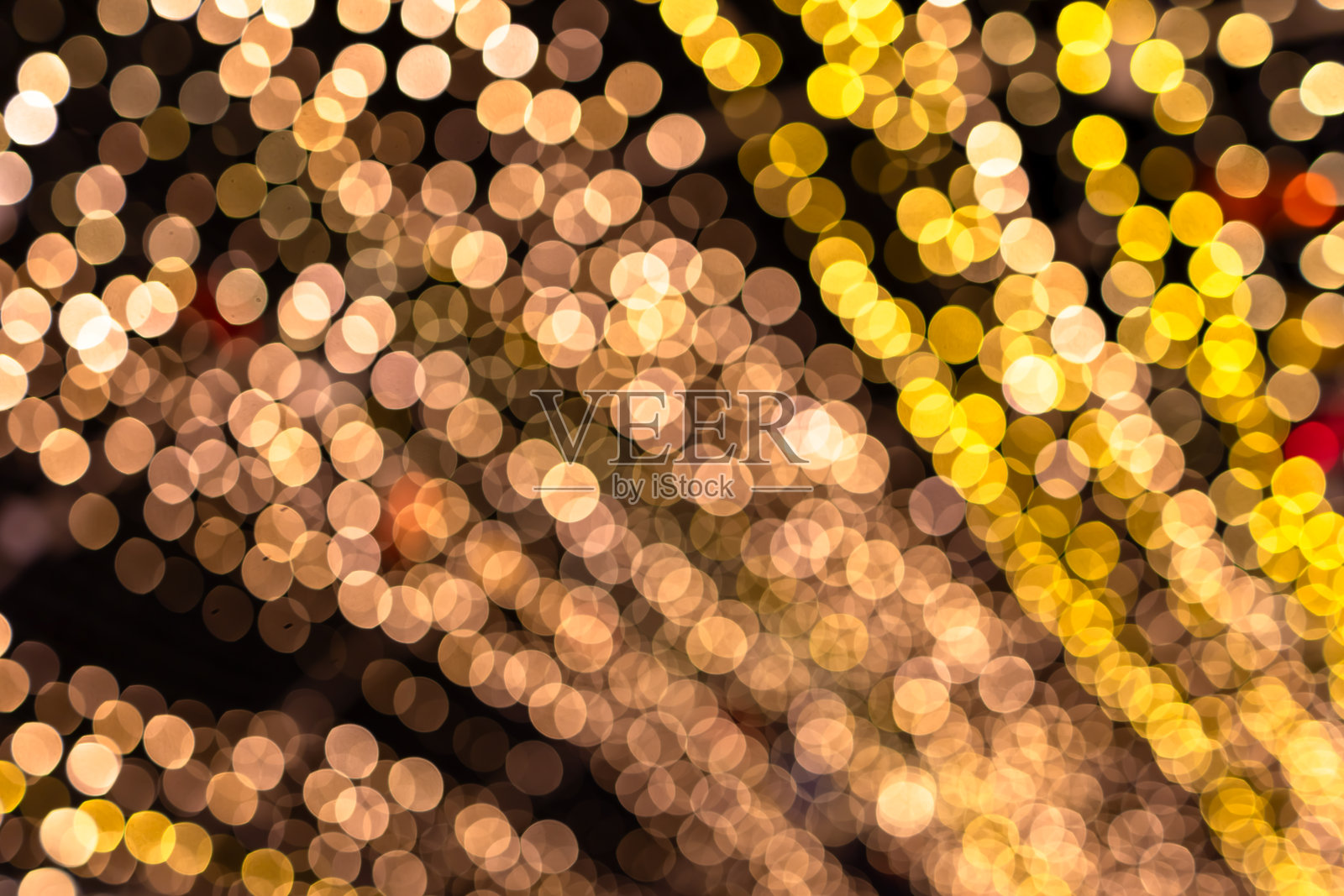 圣诞背景的金色散景,发光的彩色抽象壁纸,圣诞背景照片摄影图片