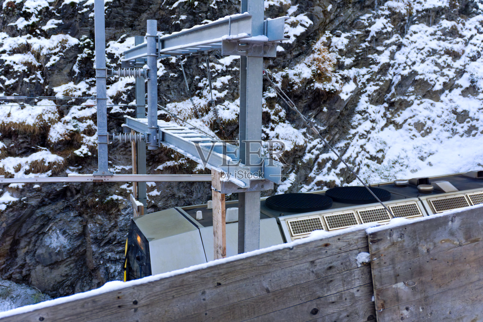 瑞士阿尔卑斯山阿尔布拉山口的风景,狭轨火车在阳光明媚的秋日雪景中穿行。照片摄影图片