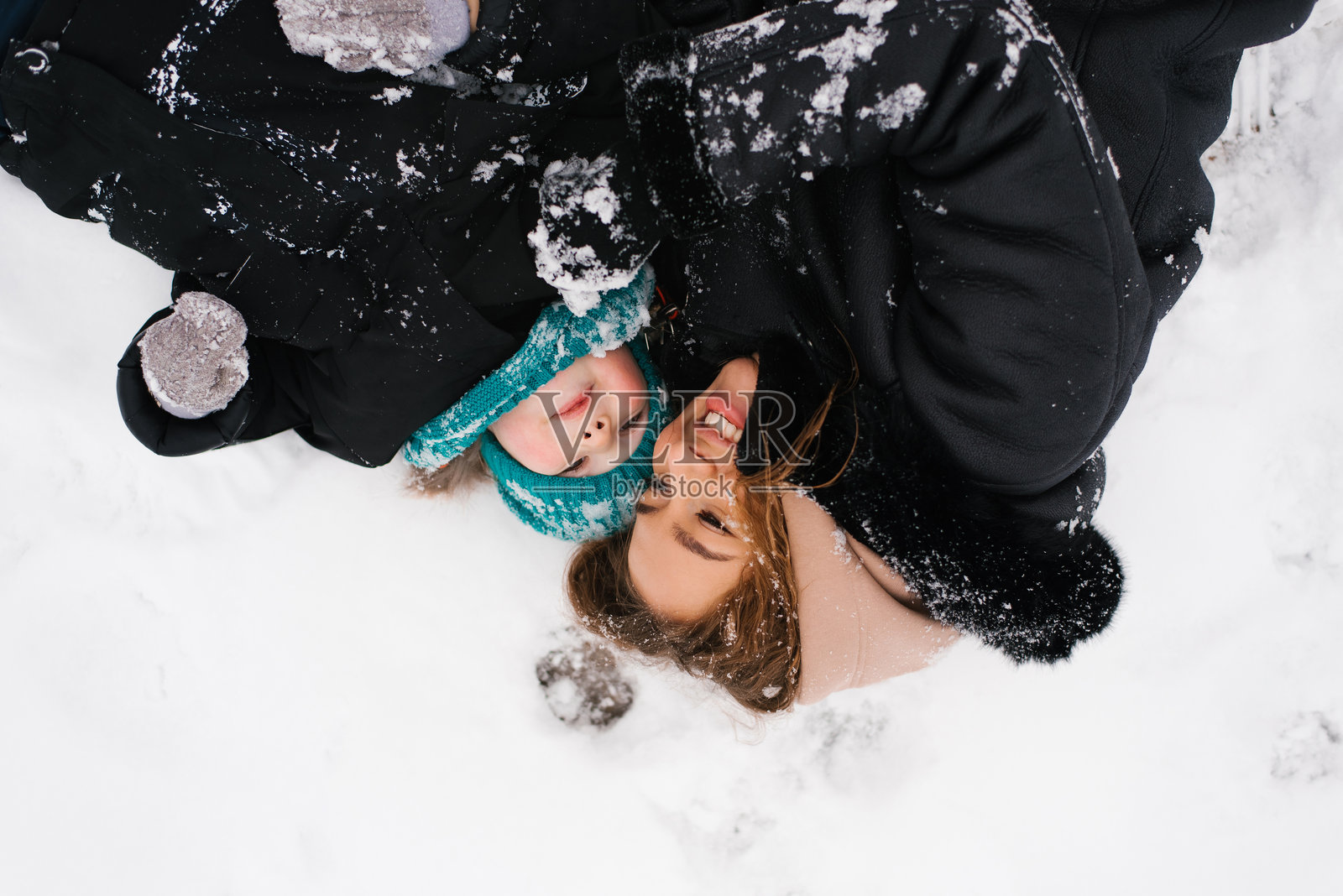 年轻的白人母亲和三岁的儿子微笑着享受冬季天气照片摄影图片