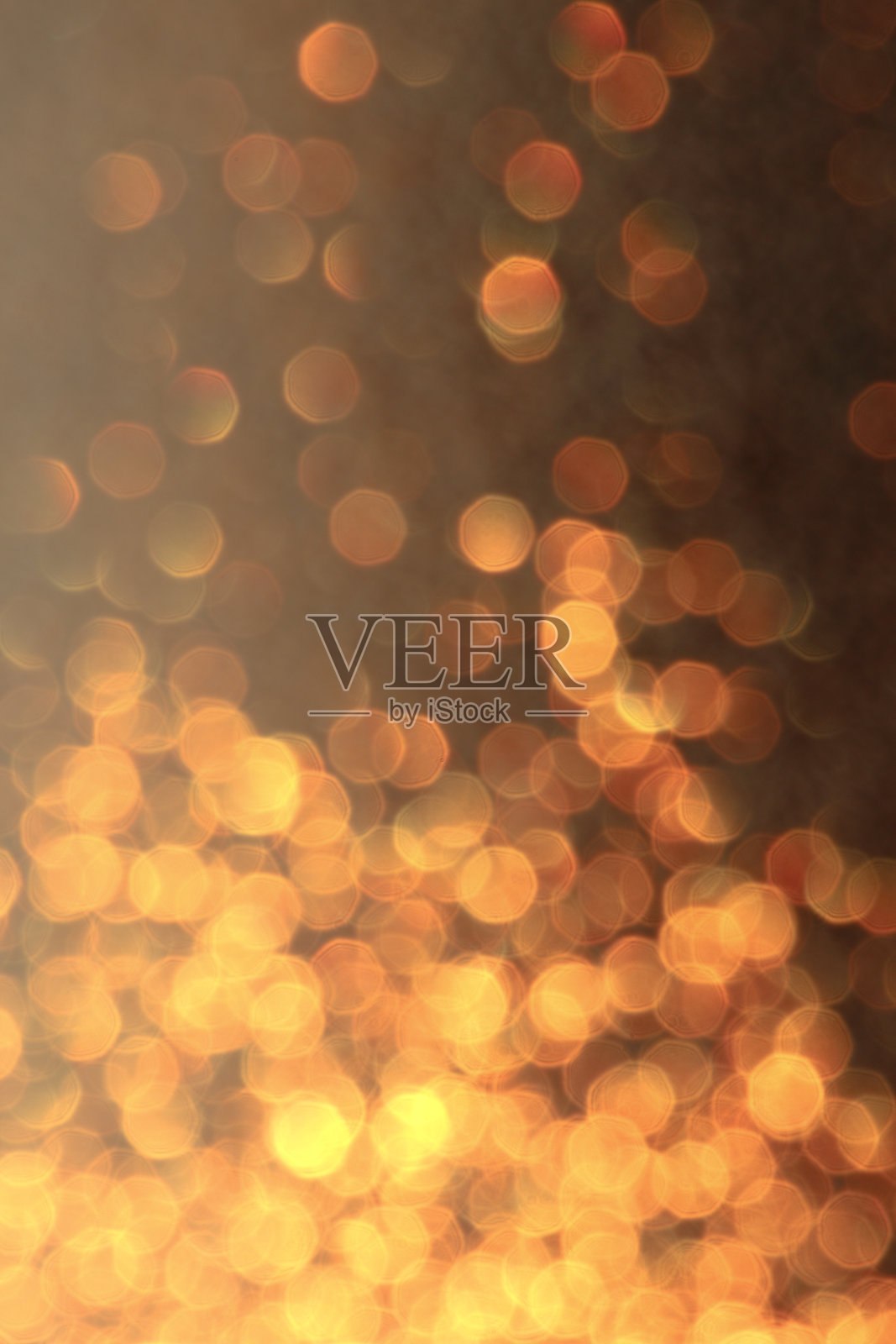 散景效果的照片,模糊的光点形成金色圆圈,背景有纹理。照片摄影图片