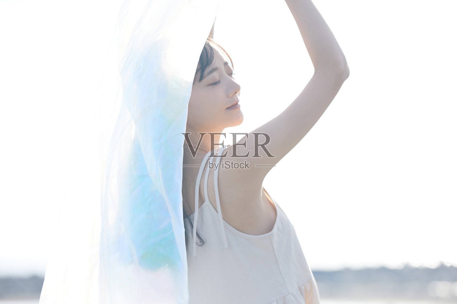 年轻的亚洲女性在海滩上漫步照片摄影图片