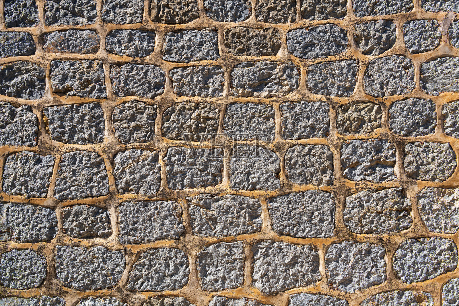 白天的加工拼贴石墙纹理。适用于横幅、背景或3D映射的纹理。照片摄影图片