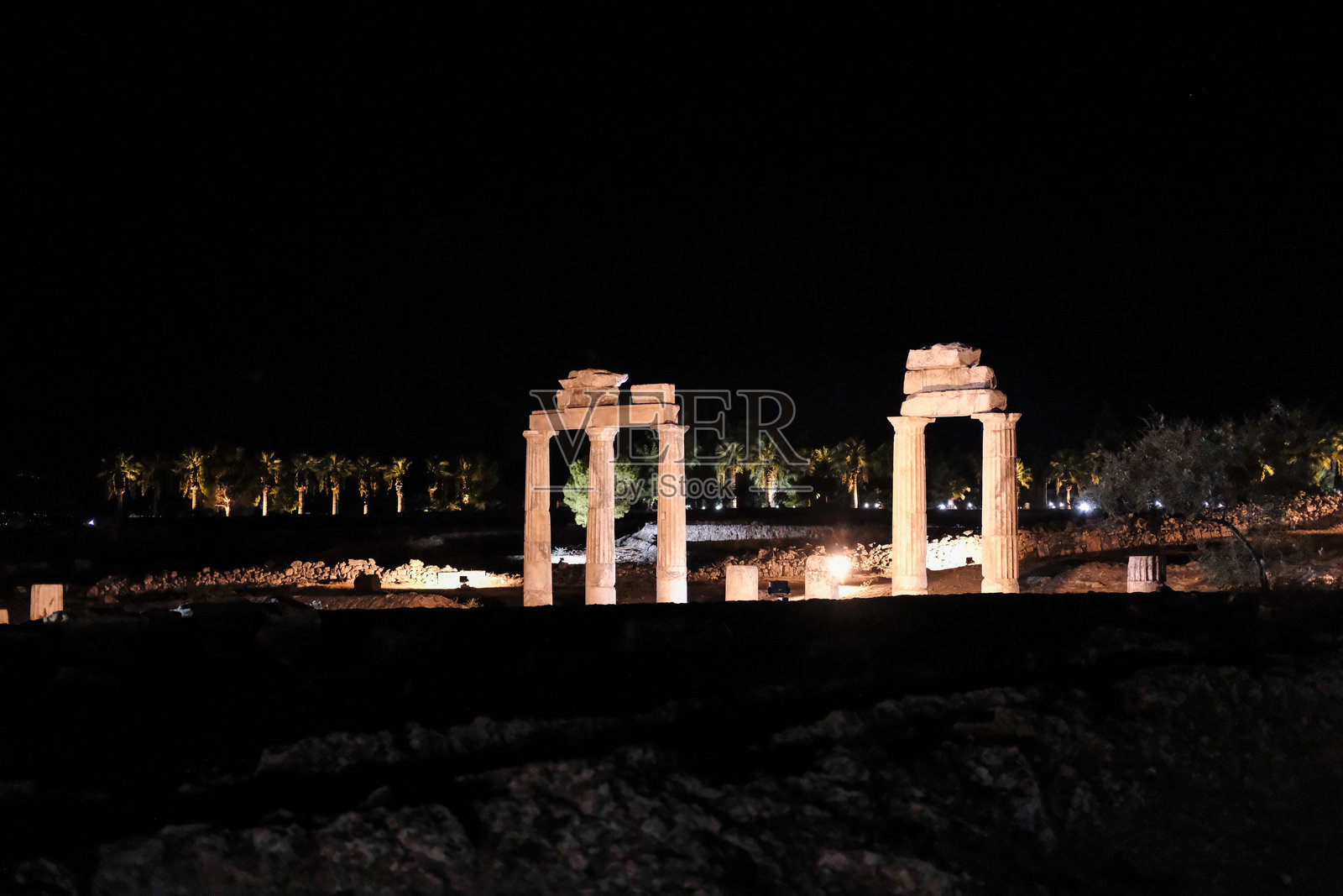 人工灯光照亮的古代遗址夜景,展示了建筑遗产和历史。照片摄影图片