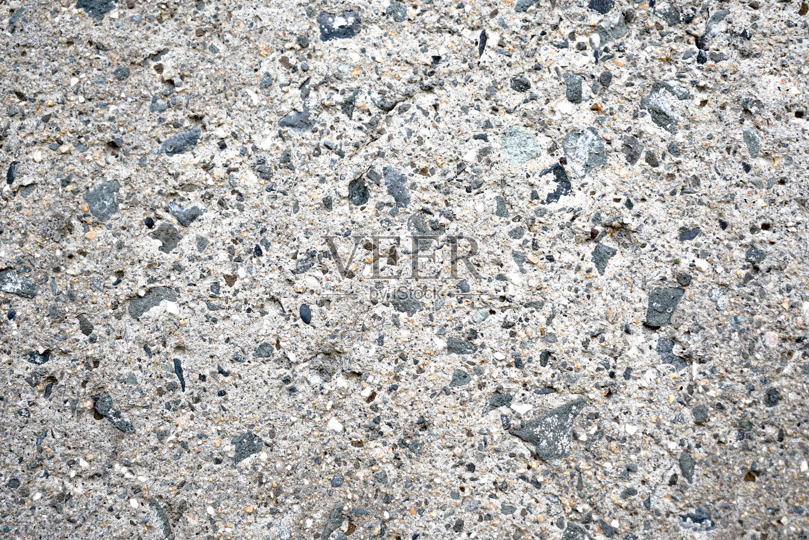混合小碎石的脏旧混凝土地面纹理背景。照片摄影图片