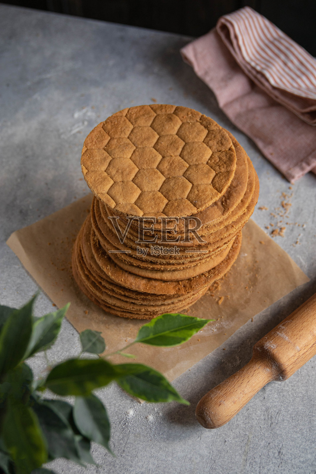 自制圆形蜂蜜蛋糕层。俄罗斯烹饪,甜点。俯视图,灰色背景。选择性焦点。照片摄影图片
