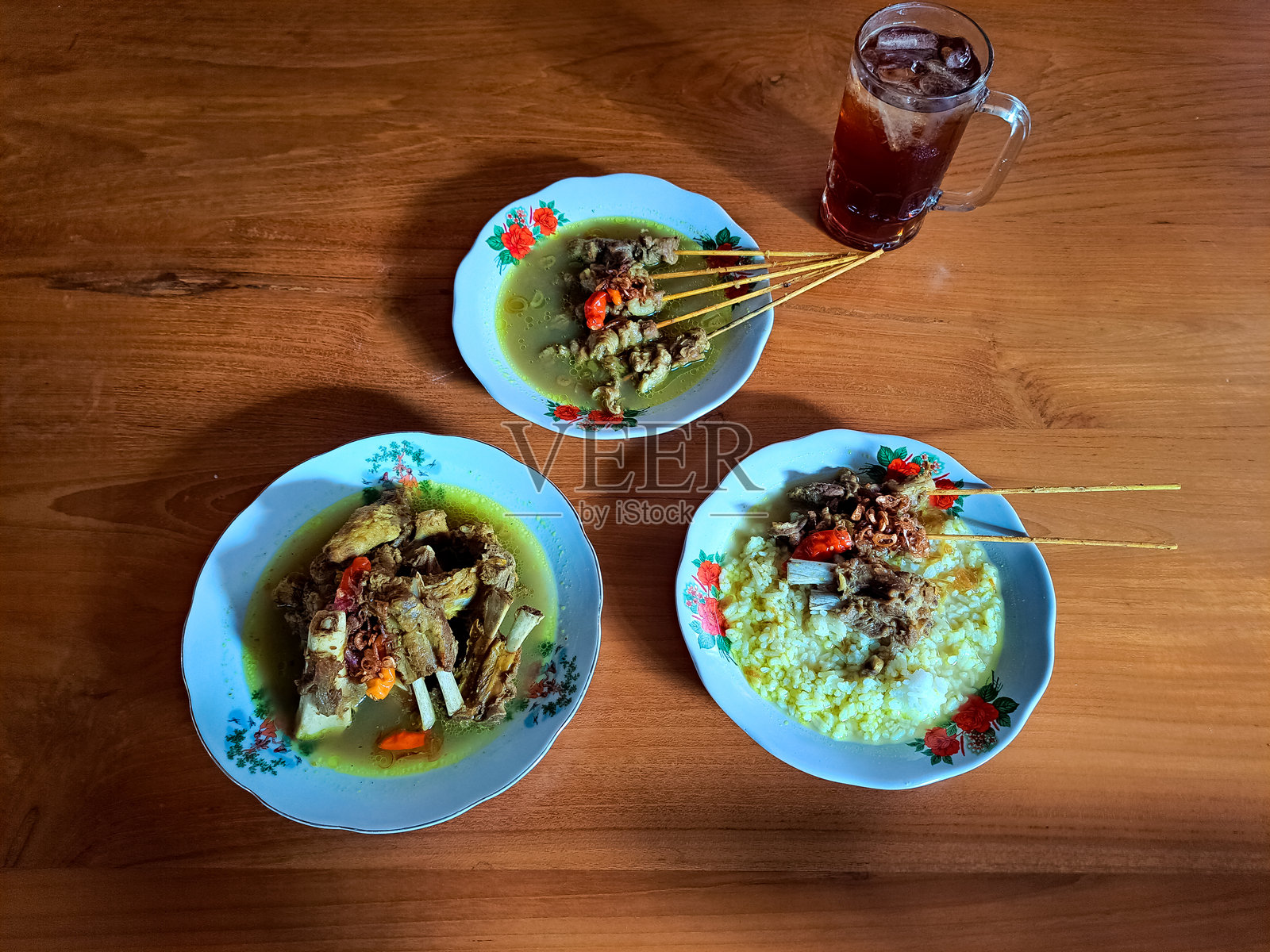 腾克伦索洛或索洛羊肉汤,腾克伦汤或山羊汤或印尼山羊炖汤,腾克伦羊肉沙爹。新鲜冰茶饮料。印尼美食菜单。照片摄影图片