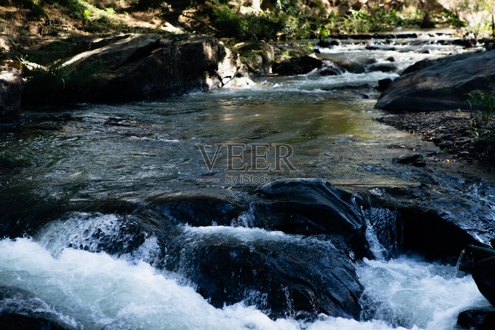 美丽的山河翡翠和色调运行在岩石顶部视图。野性和美丽的大自然照片摄影图片