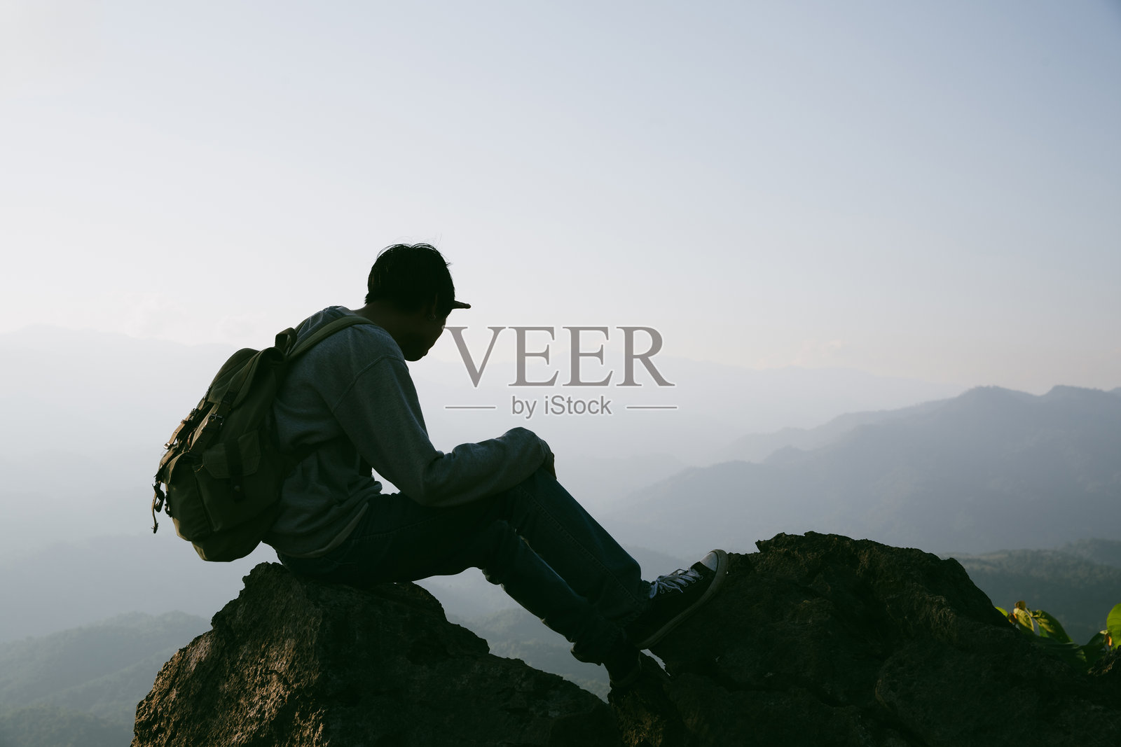 背包客男性在户外徒步旅行,享受旅行生活方式和冒险概念。戴着帽子的背包客与游客一起参加绿色山脉之旅,感受大自然的美丽和广阔的天空。照片摄影图片