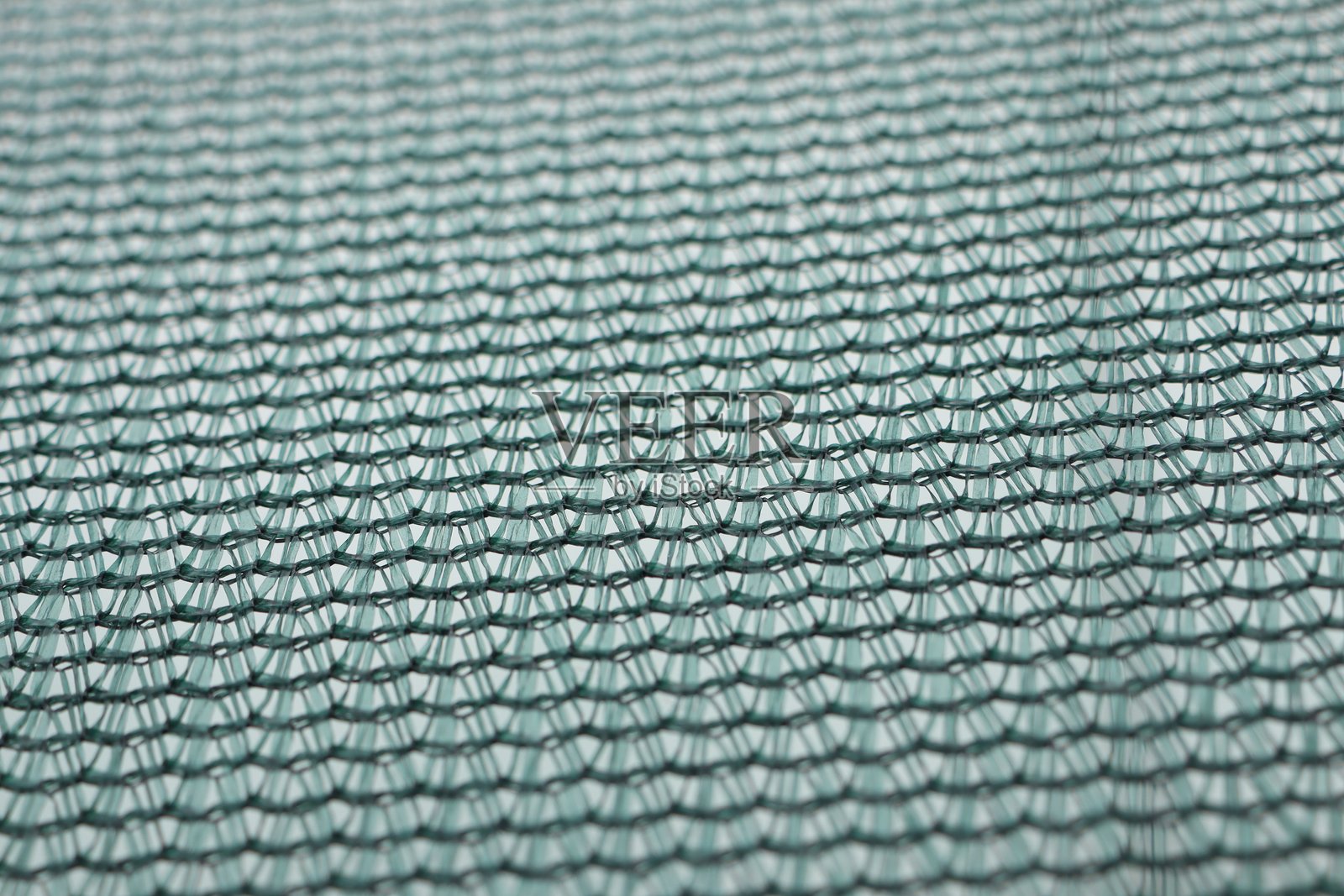 一块特写的绿色织物,展示出独特而迷人的纹理图案照片摄影图片