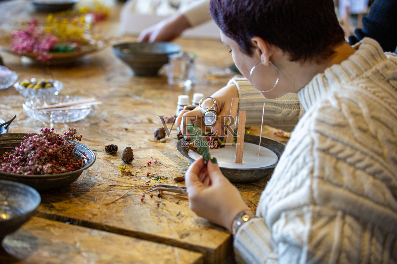 女性在工作坊制作装饰性香氛蜡烛照片摄影图片