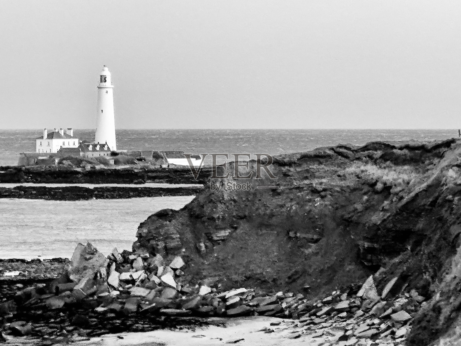 海岸侵蚀与圣玛丽灯塔在背景中照片摄影图片