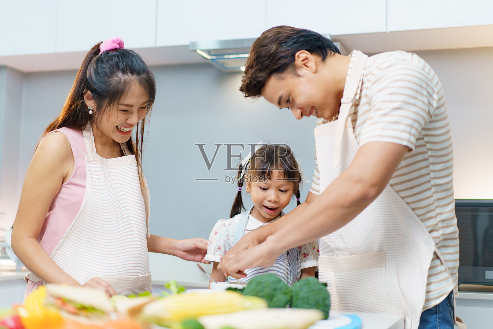 亚洲家庭在厨房准备食物。照片摄影图片