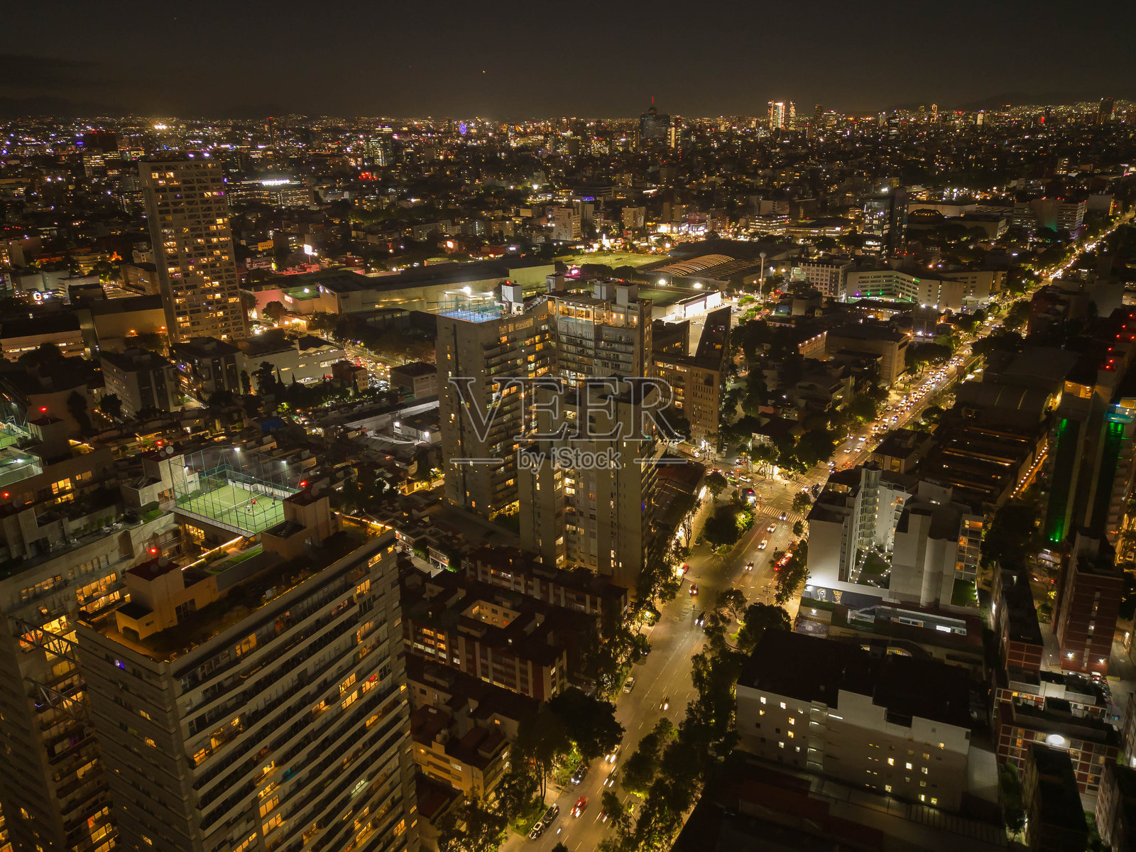 在夜晚,墨西哥城南部被闪耀的摩天大楼照亮,主导着城市的天际线。照片摄影图片