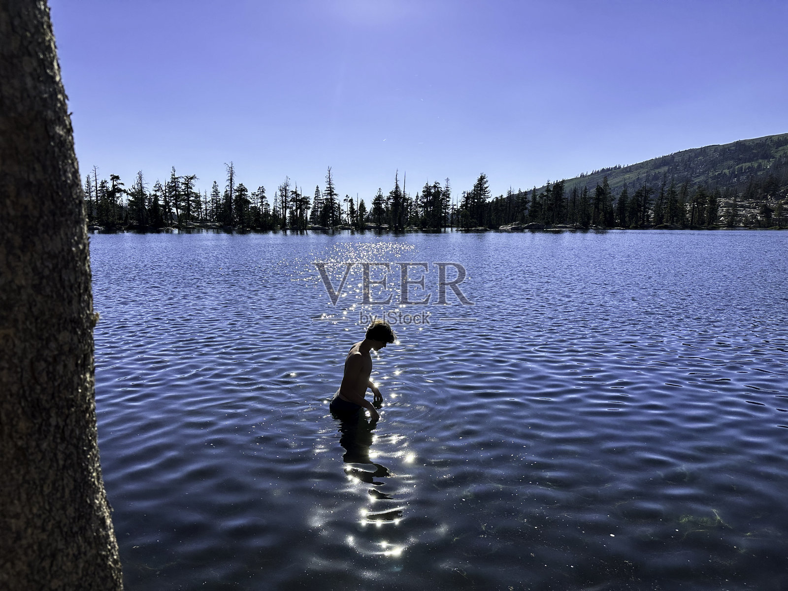 少年在偏远湖泊中进行冷水浸泡照片摄影图片