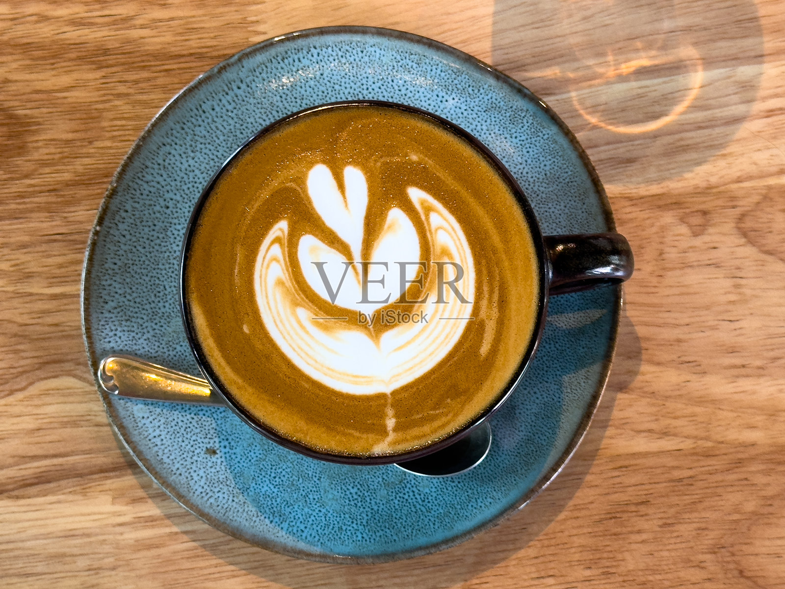 木桌上的卡布奇诺咖啡杯照片摄影图片