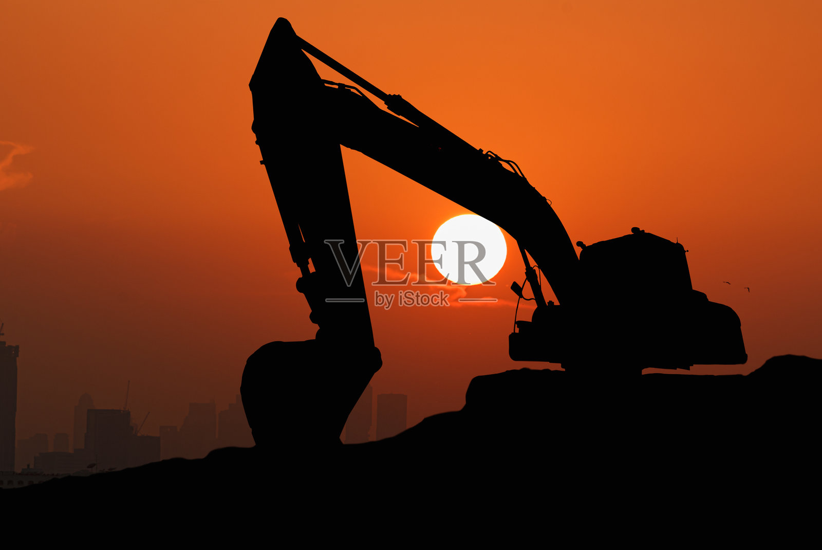 挖掘机剪影。照片摄影图片