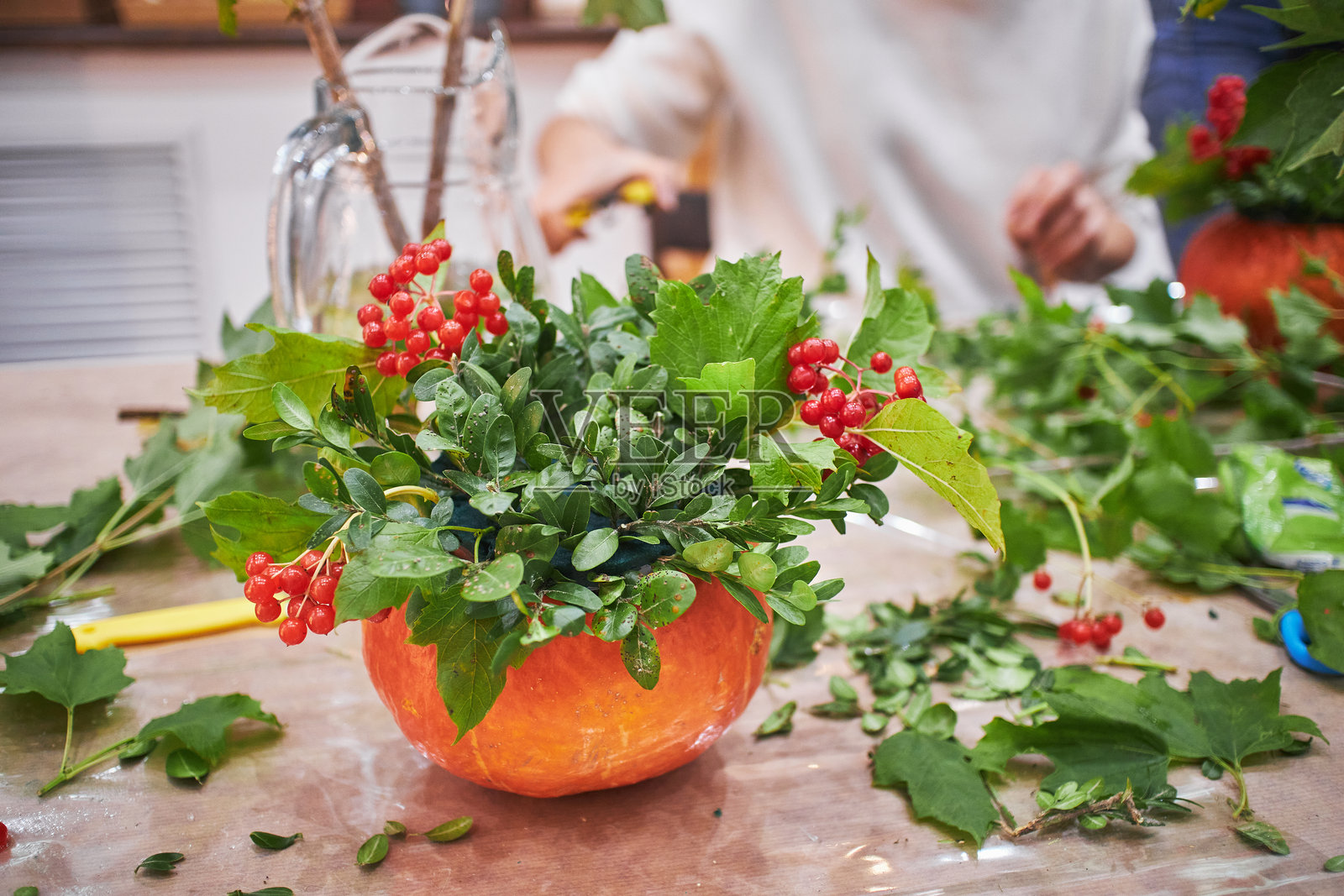 花束制作大师班。南瓜中的秋季花束。花卉排列,亲手制作美丽花束。照片摄影图片
