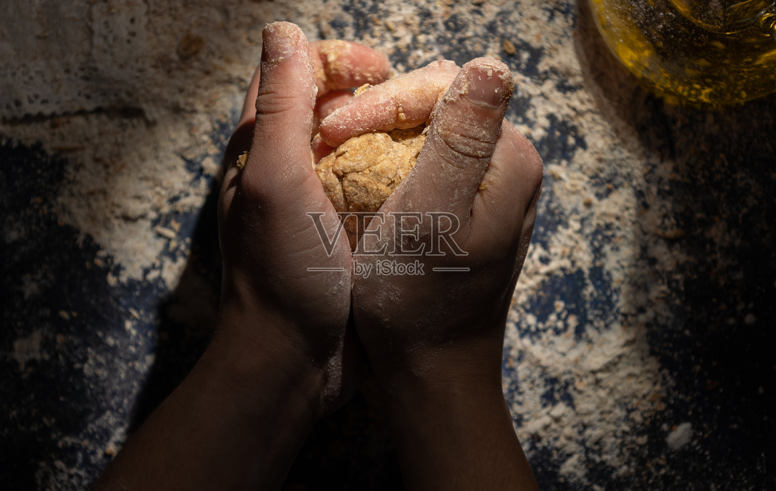 男性双手在深色背景上揉全麦面粉照片摄影图片
