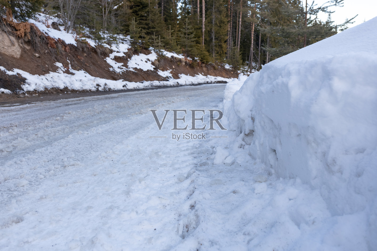 雪-covered的山中,雪白的道路和高大的雪-covered树木照片摄影图片