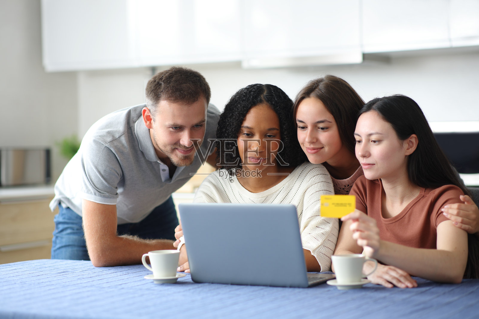 四个跨种族的朋友在网上购物照片摄影图片