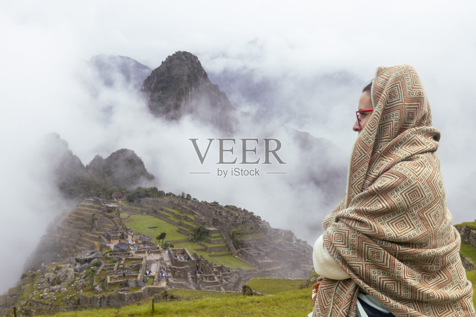 女人凝视着著名的古代印加遗址马丘比丘,位于秘鲁库斯科地区照片摄影图片