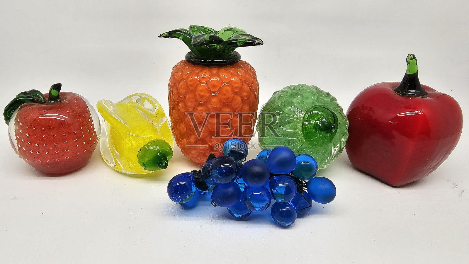 各种仿真水果,如苹果、橙子、菠萝等,采用玻璃制成,家居装饰,美丽的玻璃艺术。照片摄影图片
