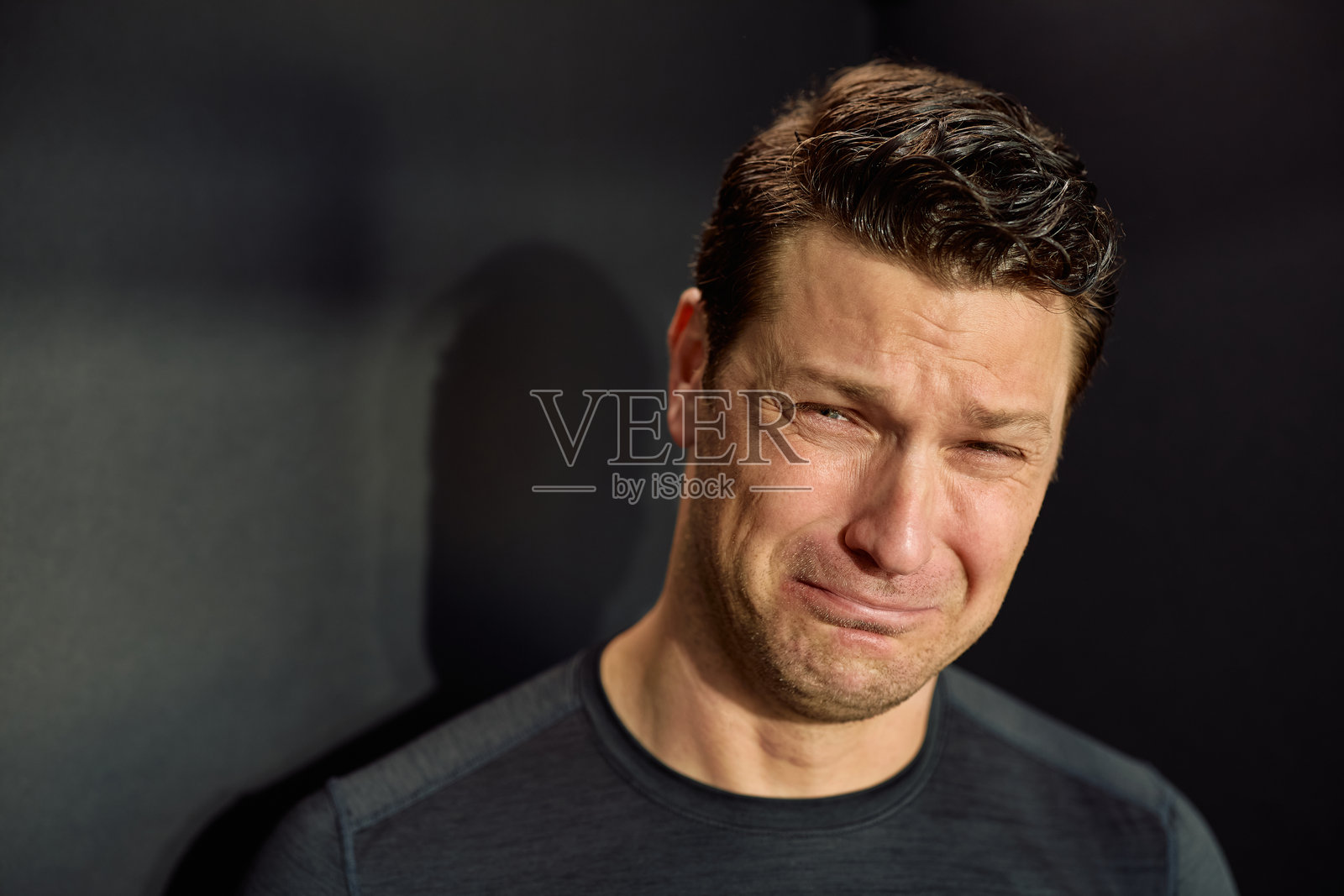 悲伤男子的肖像,正在哭泣。照片摄影图片