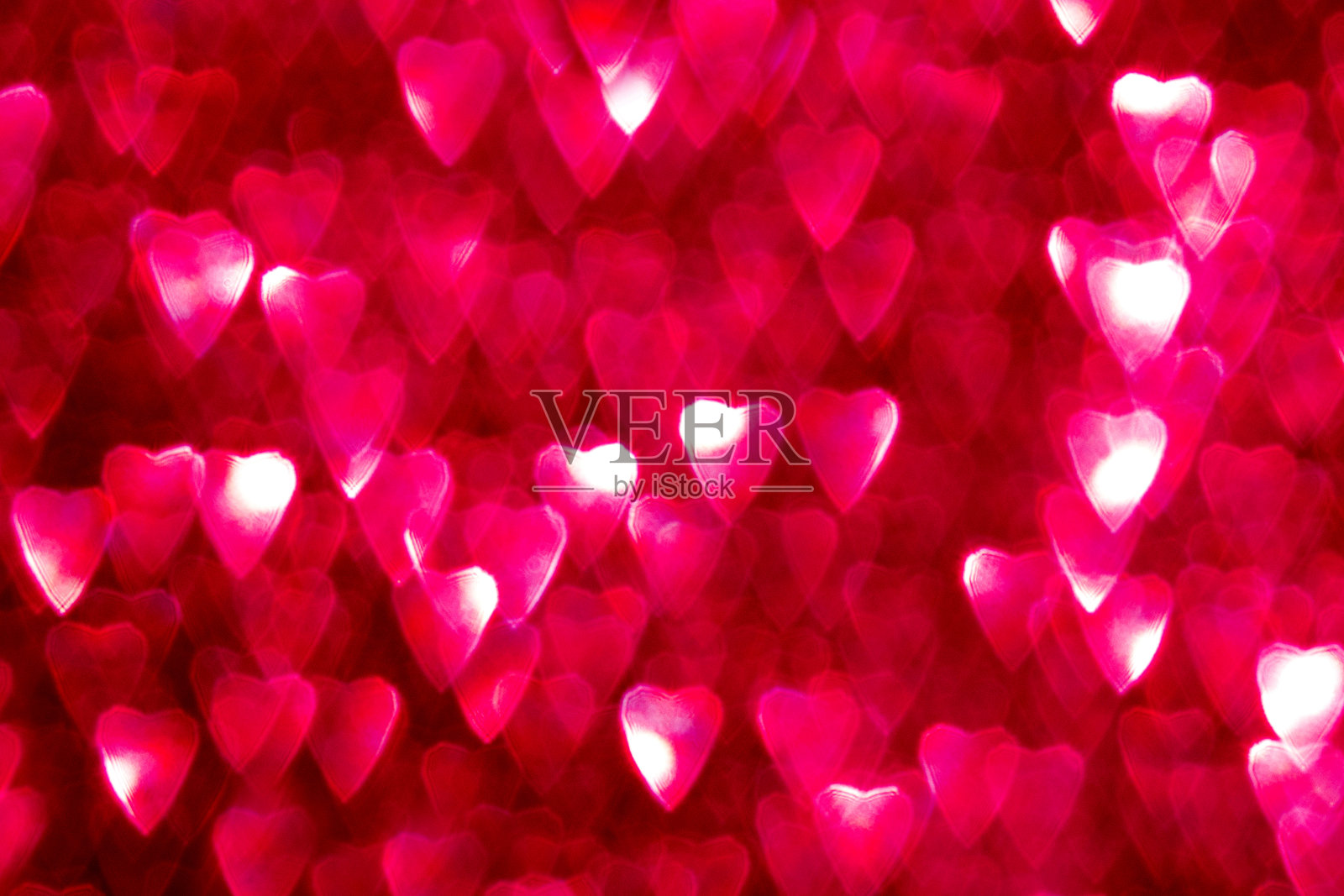 明亮的粉色心形散景背景,散发着浪漫的氛围照片摄影图片