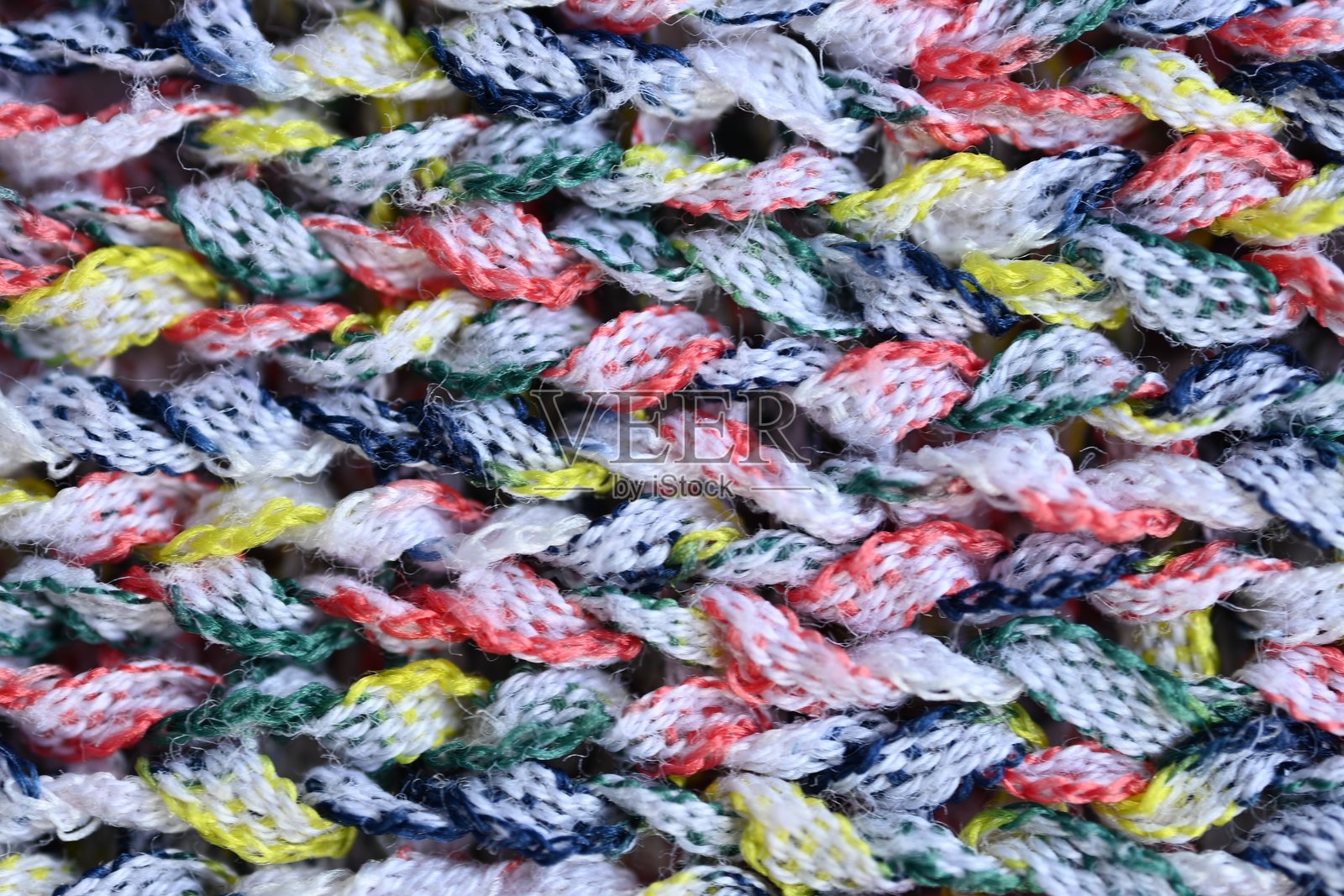 多彩编织面料纹理的顶部照片作为背景,特写多彩编织的光滑质感照片摄影图片