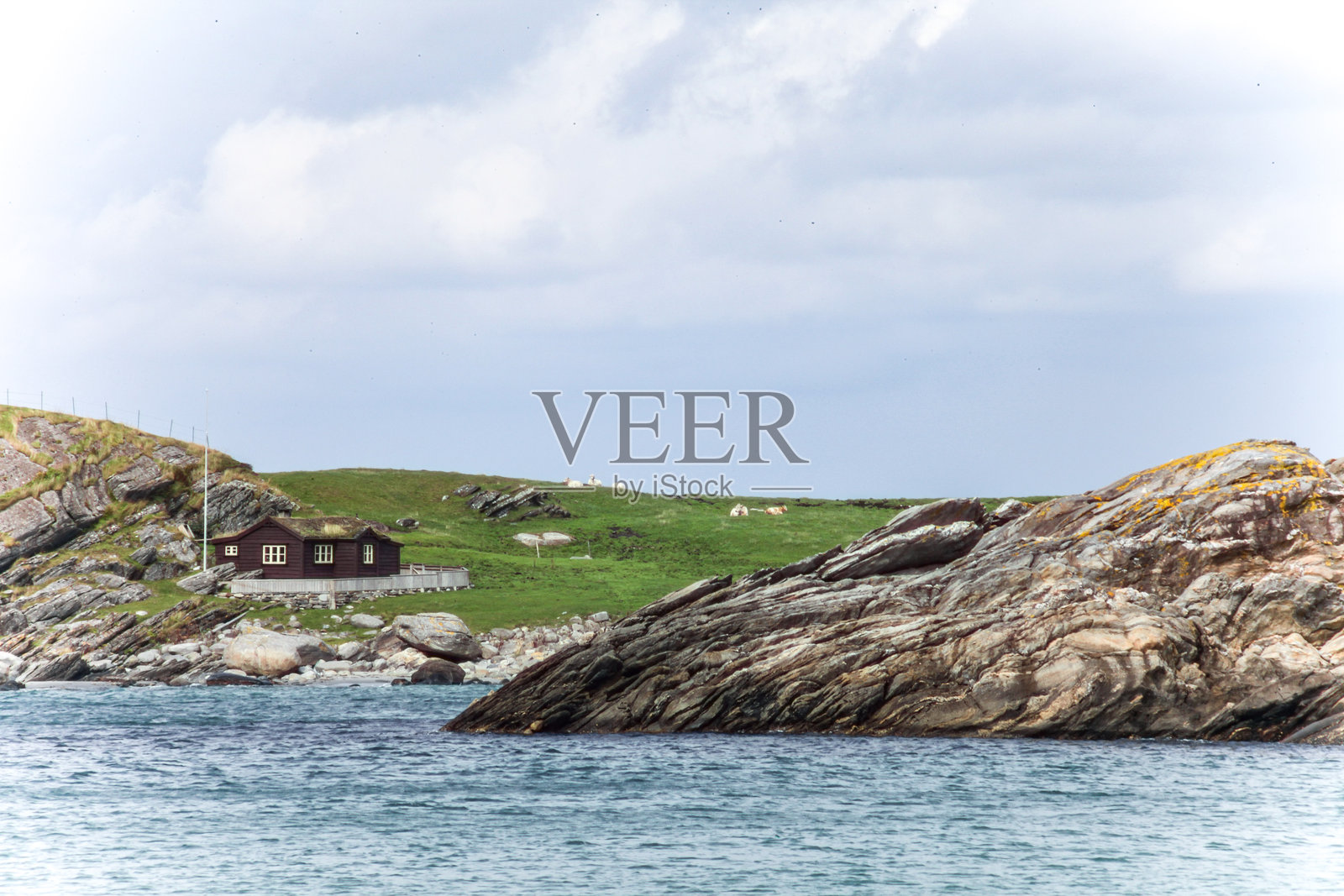 挪威的岩石海滩,前景有一块大岩石照片摄影图片