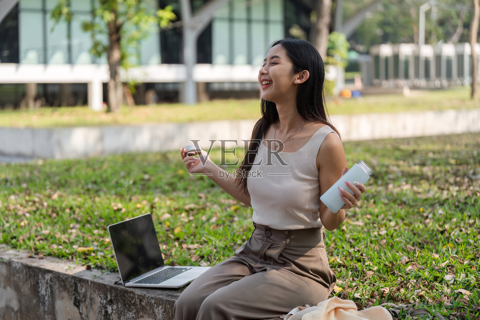 快乐的时刻。女人在户外享受零食和饮料时欢笑。照片摄影图片
