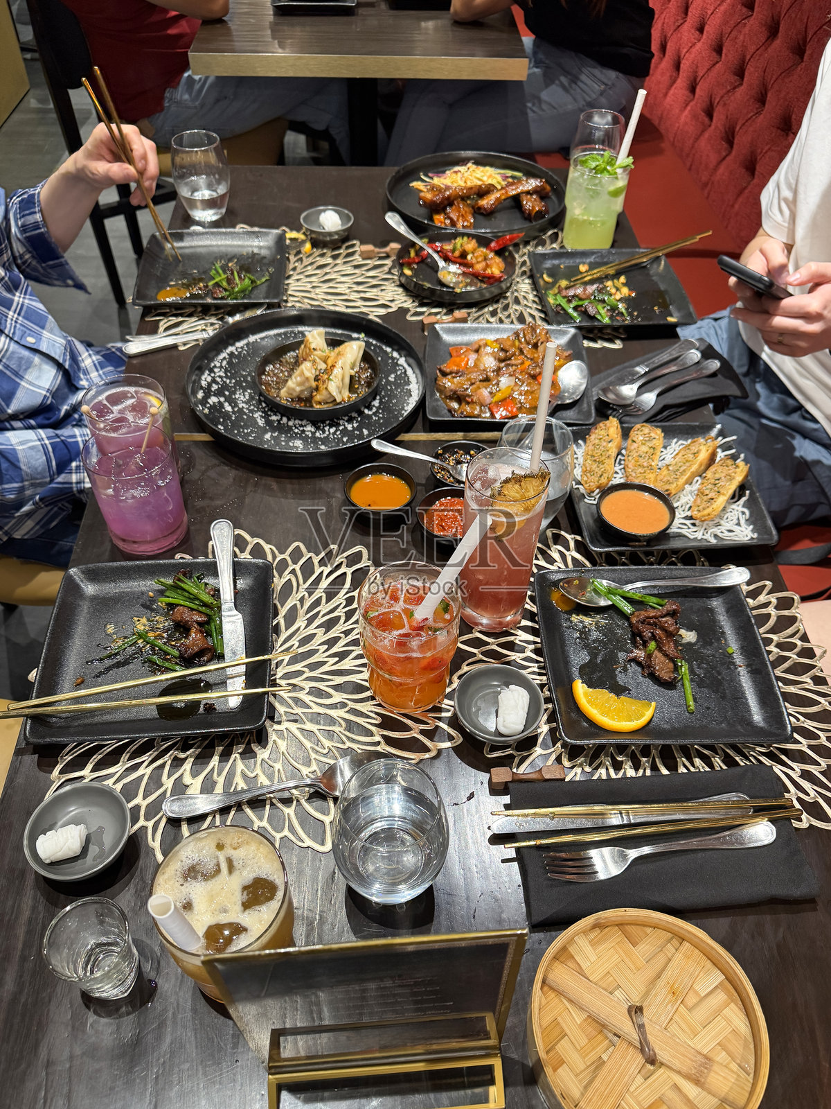 用筷子吃手机,享受中国饺子和春卷 / 俯视盘子,美味的亚洲食物照片摄影图片