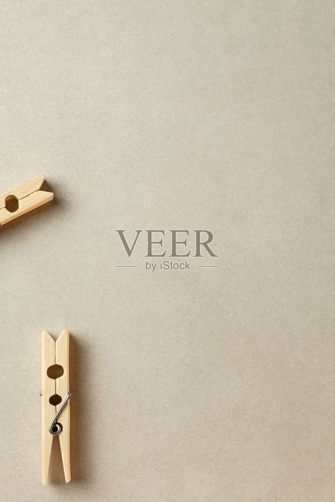 精致的木质衣夹静静地放在柔和的中性色背景上照片摄影图片