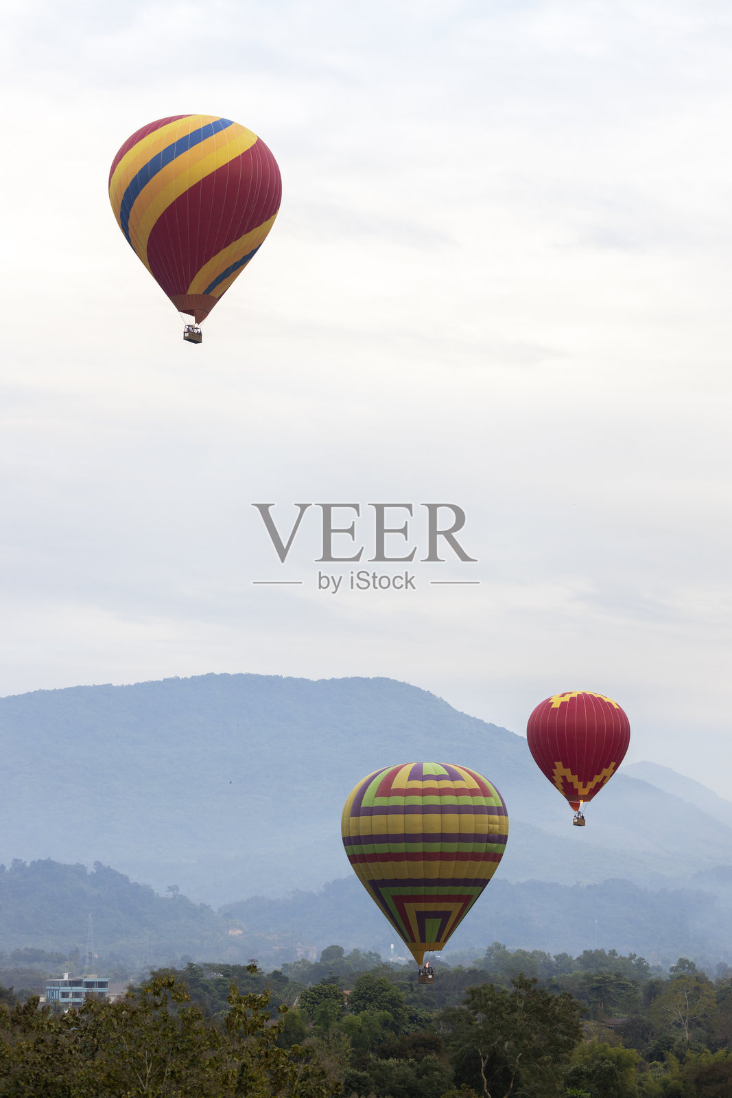 五彩缤纷的热气球飞越山脉照片摄影图片