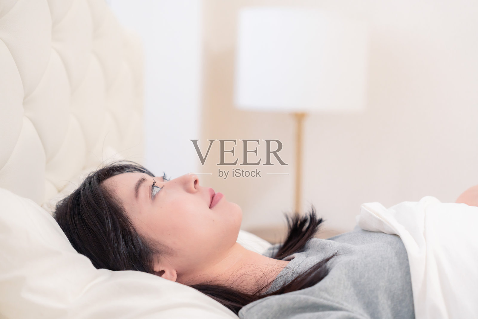 年轻女性在床上睡觉照片摄影图片