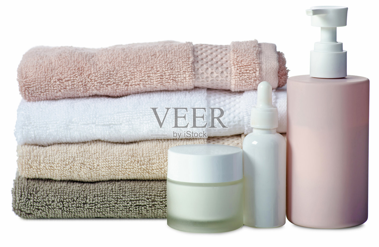 叠放整齐的毛巾与化妆瓶、SPA和浴室产品照片摄影图片