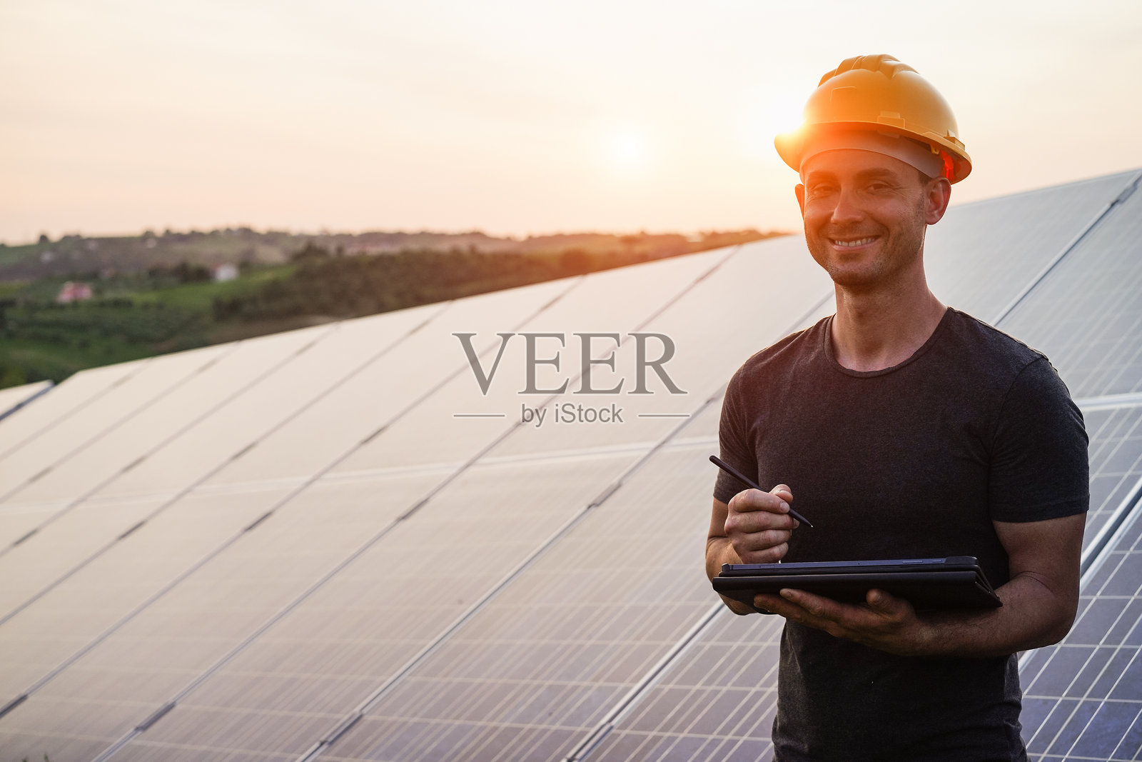 在户外太阳能电池板工厂工作的工程师 - 光伏、可再生绿色能源和环保概念 - 重点关注面部照片摄影图片