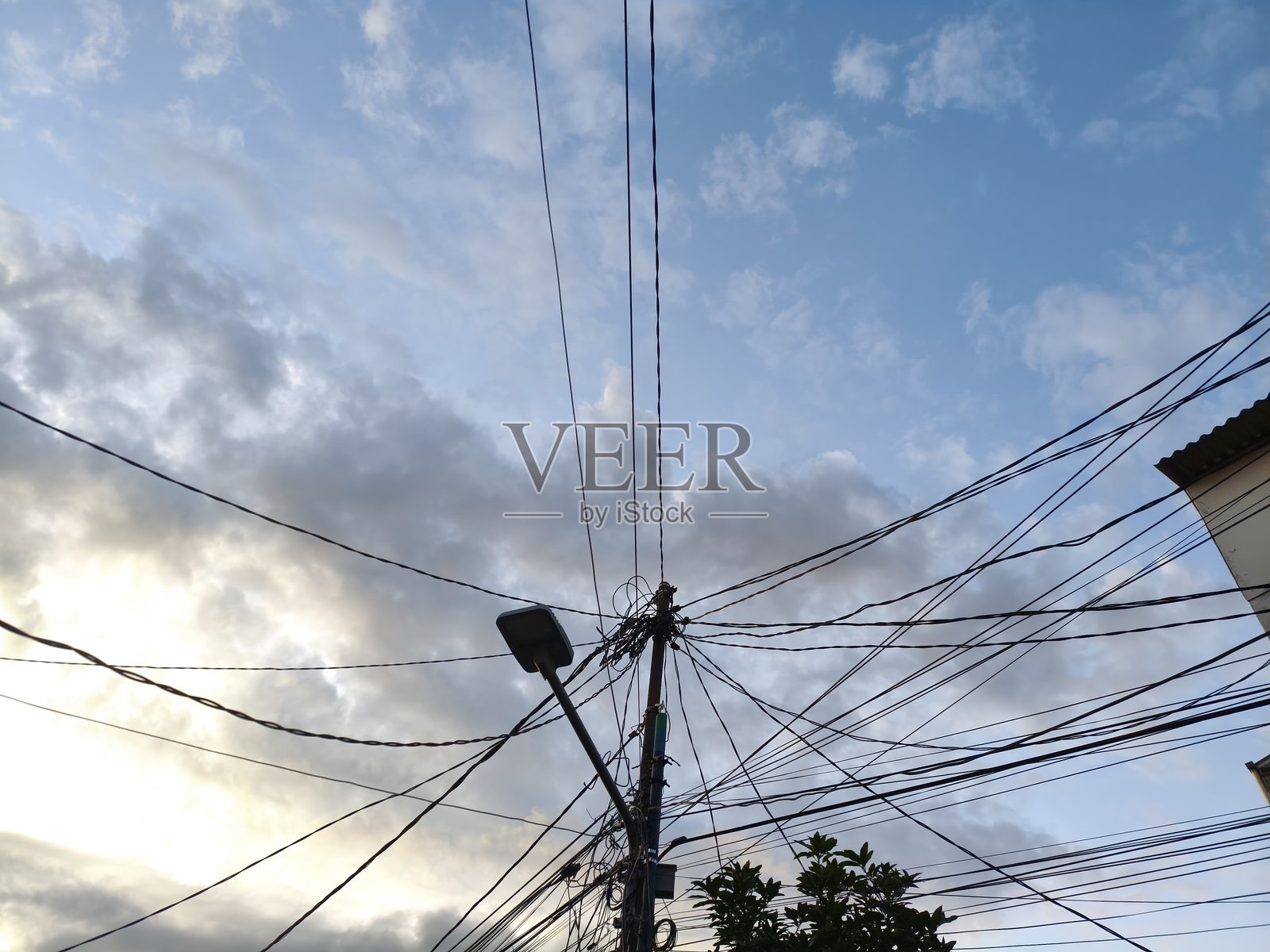 夕阳下凌乱的电线和电话线照片摄影图片