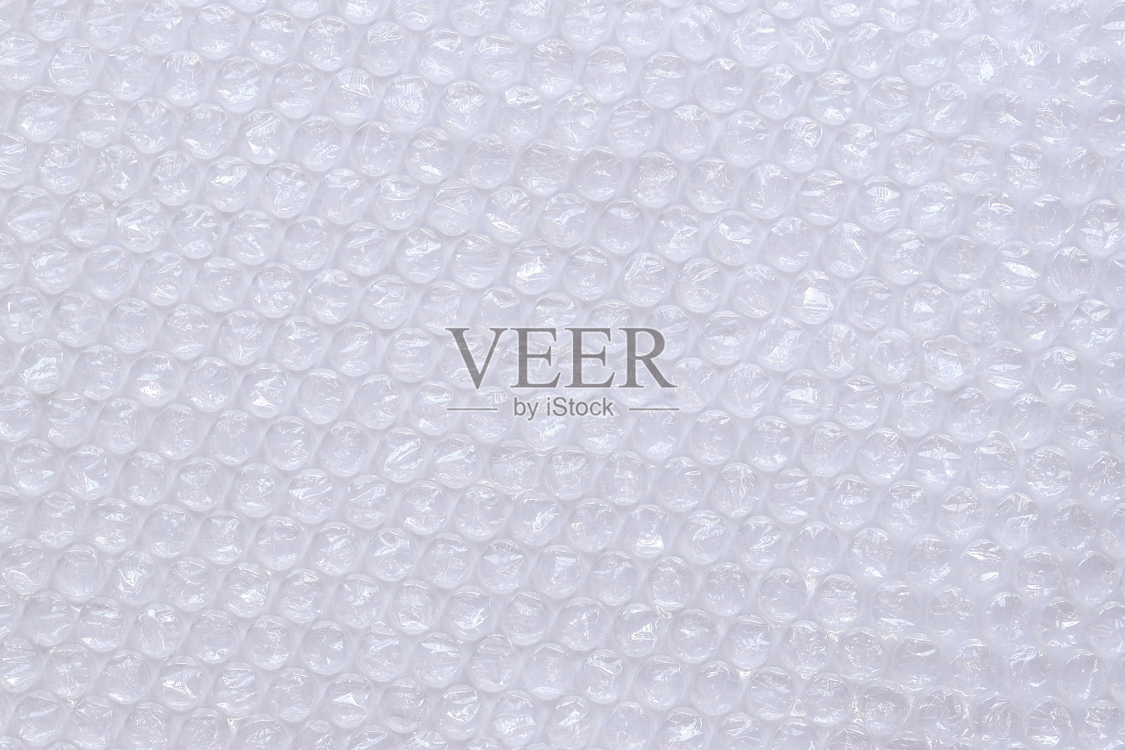 气泡包装膜,俯视图。透明气泡膜在浅色背景上。照片摄影图片