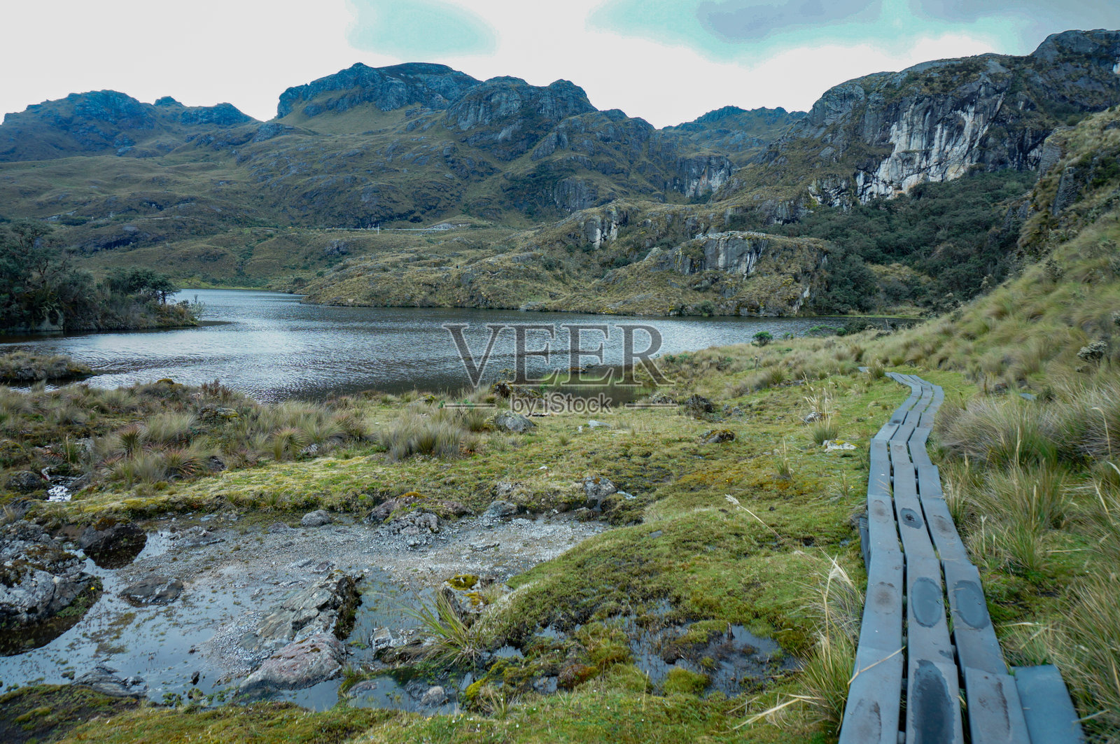 一条小路通向被群山环绕的湖泊照片摄影图片