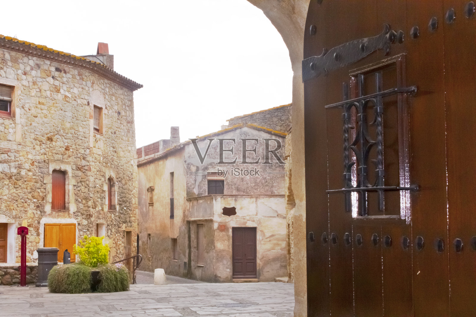 通过古老的开门看到赫罗纳的帕尔斯镇广场景观。照片摄影图片