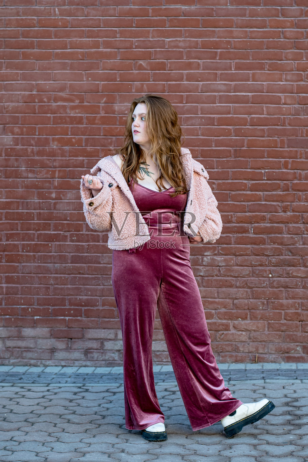 时尚的红发女性在市中心穿着奇特的粉色造型照片摄影图片