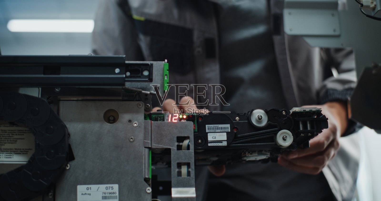 穿着制服的ATM技术人员正在维护现金取款机照片摄影图片