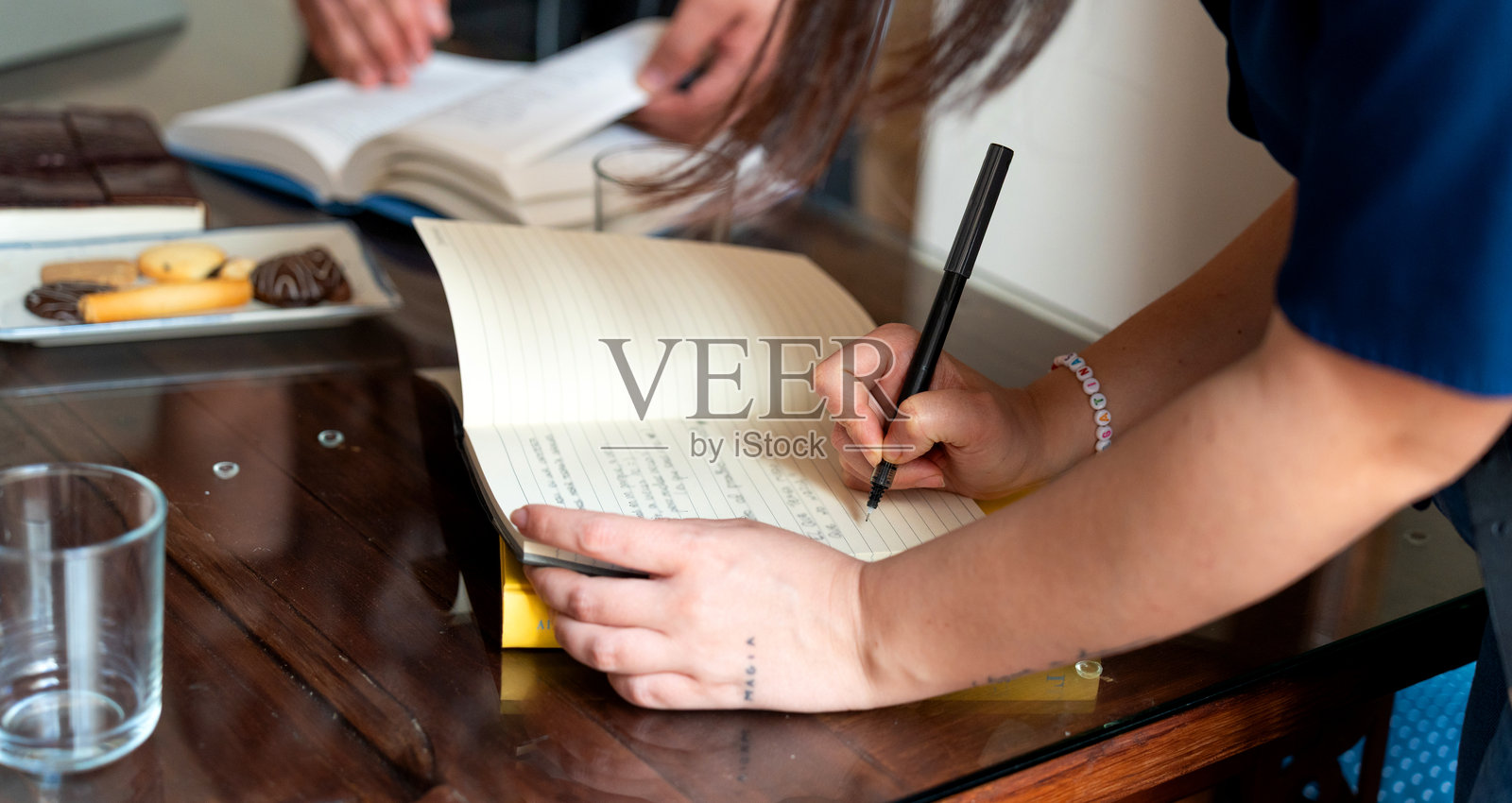 作家在读书会会议中做笔记照片摄影图片